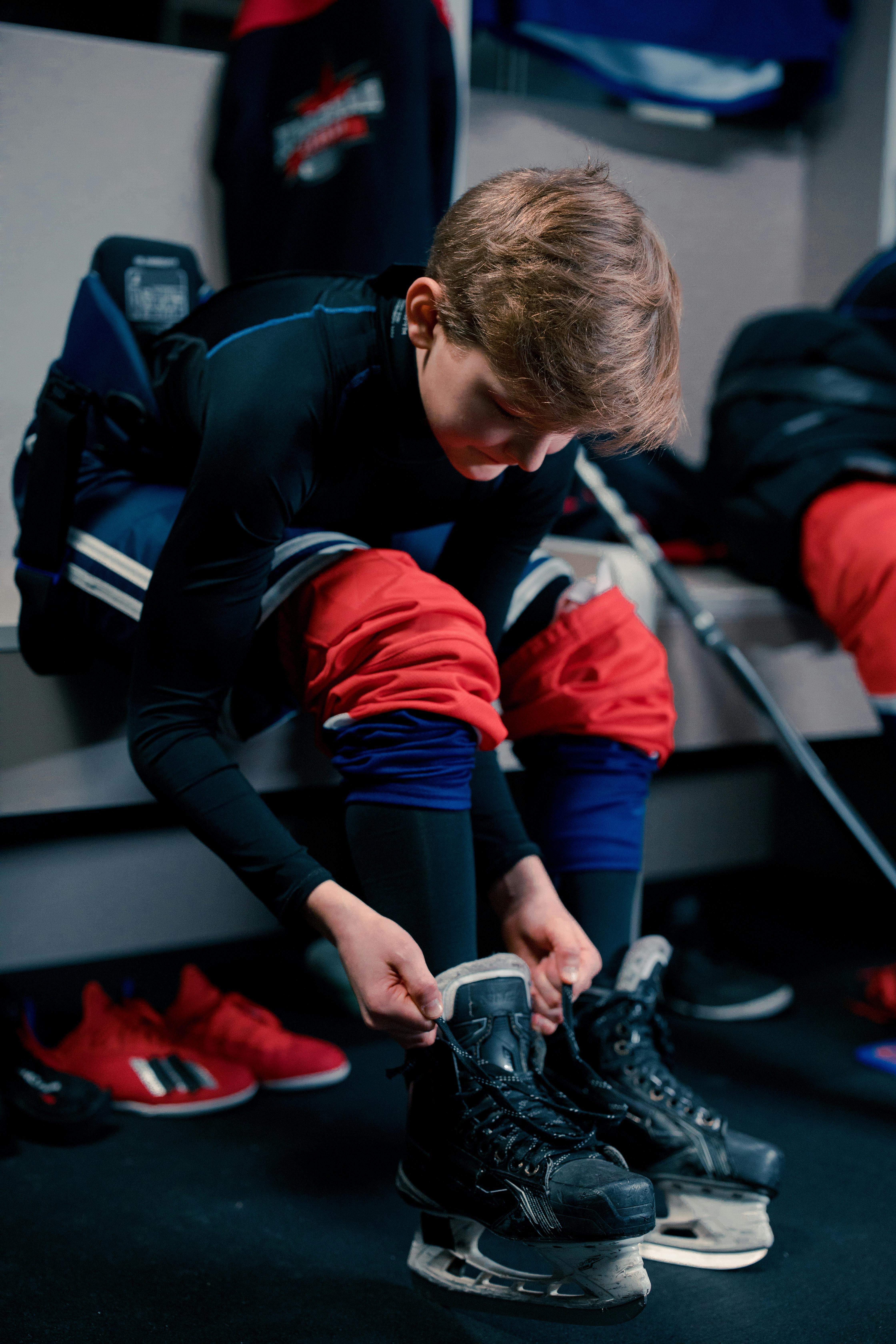 a boy putting on hockey skates