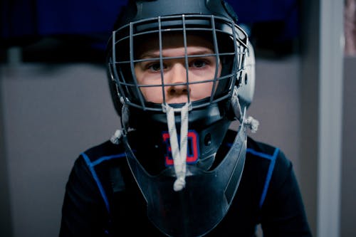 A Boy Wearing a Hockey Helmet