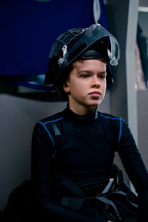 Man in Black Long Sleeve Shirt Wearing Hockey Black Helmet