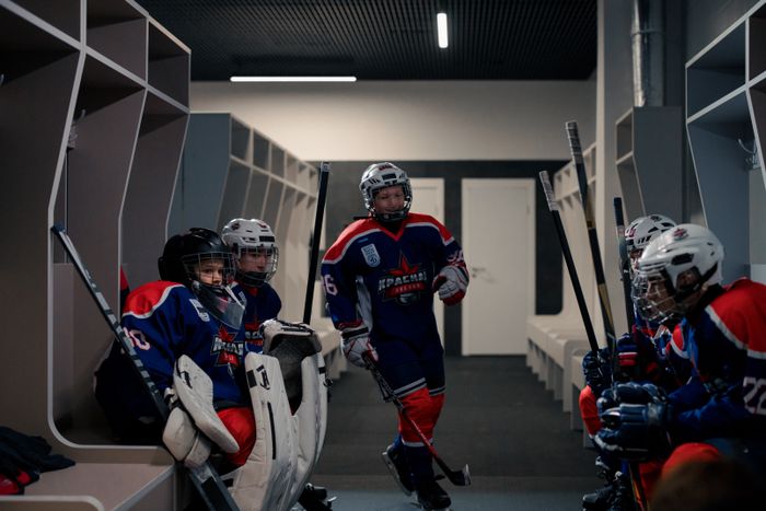 Coach talking through tactics with young players