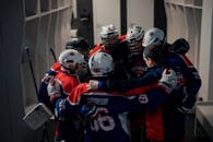 2 Men in Blue and Red Jersey Shirt Wearing Helmet