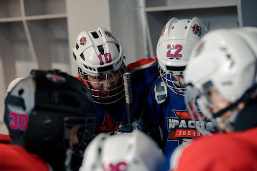 Teen hockey players in locker room getting ready, showcasing teamwork and team spirit.