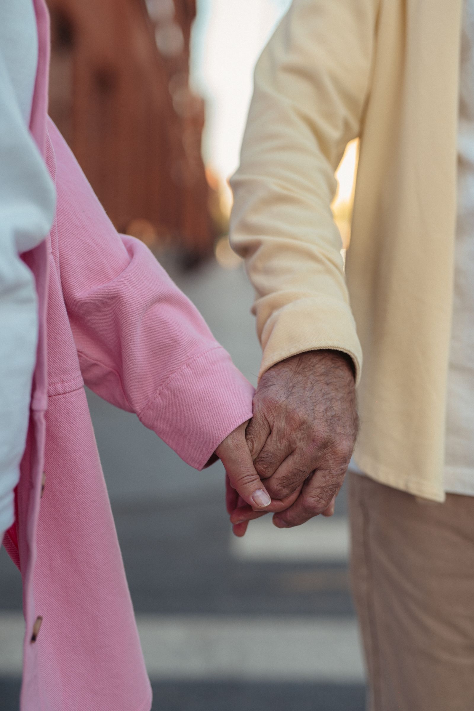 An elderly couple's hands, held