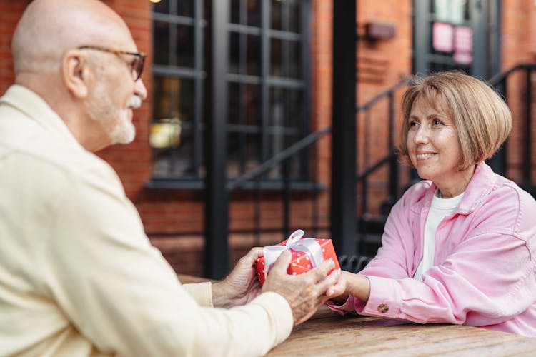 A Man Giving A Present To A Woman