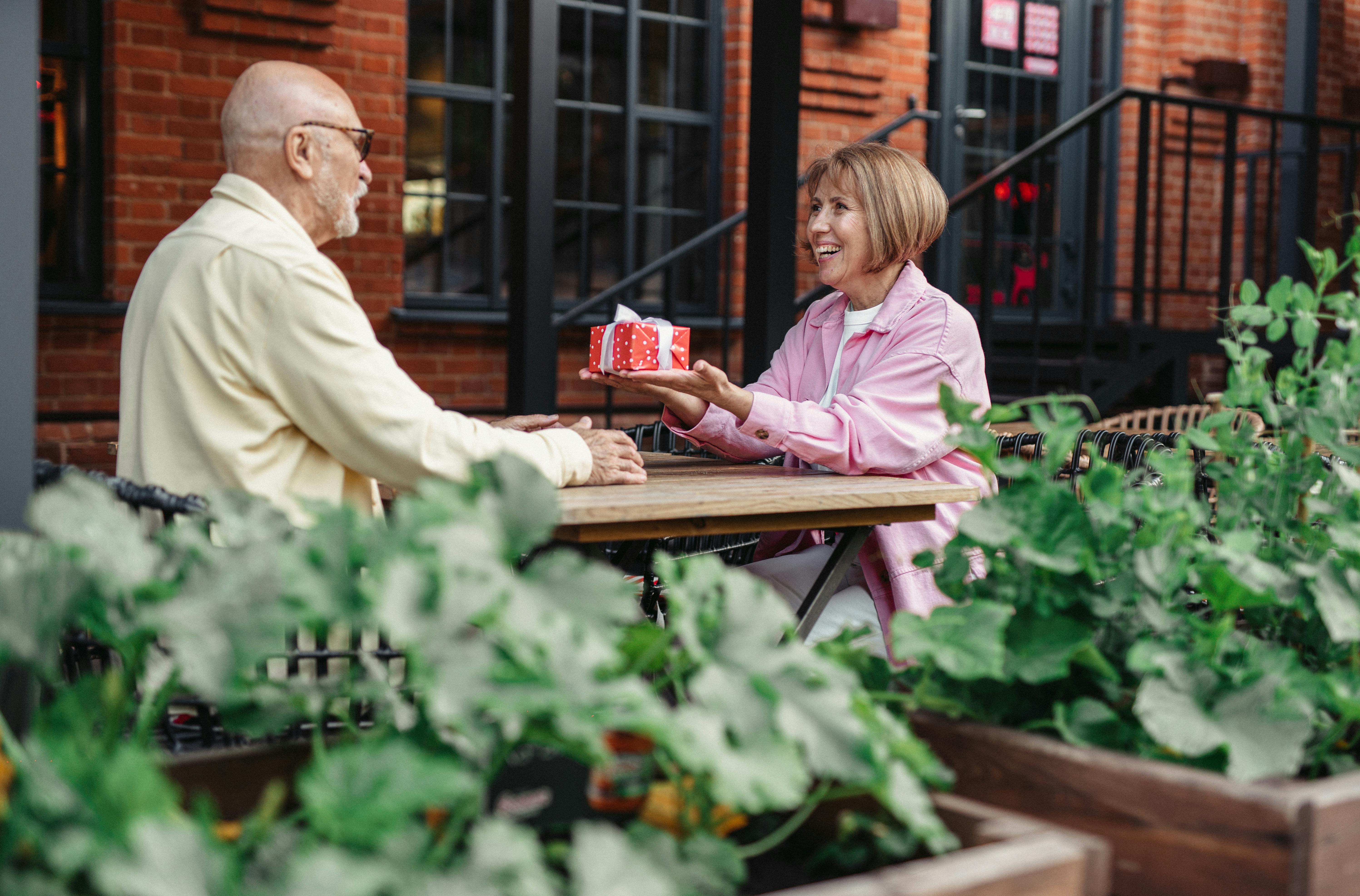 an elderly woman giving a gift