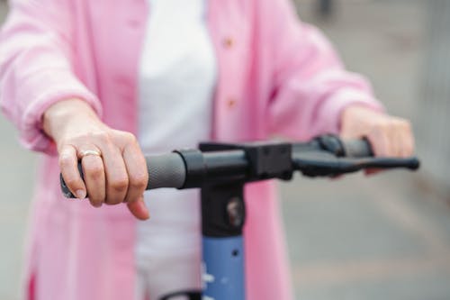 Free A Person in Pink Jacket Ridding Electric Scooter Stock Photo