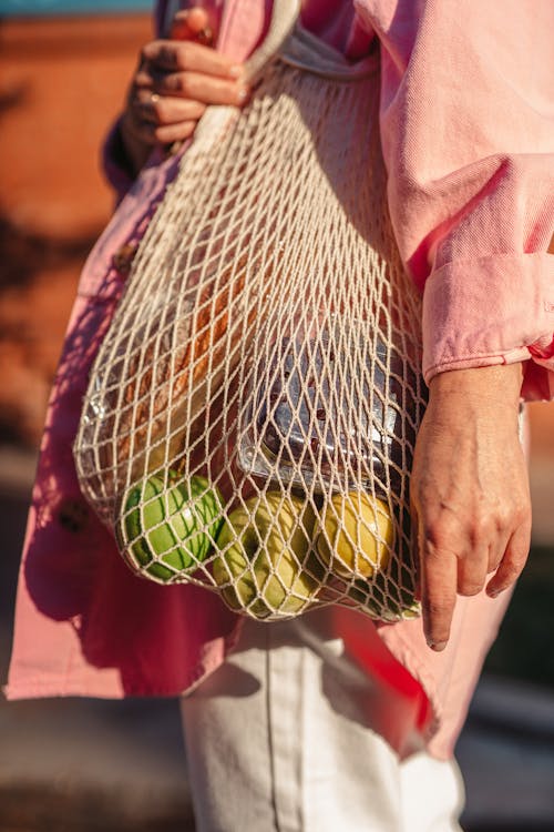 A Woman Carrying a Mesh bag