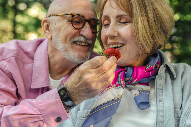 Man Giving A Strawberry To A Woman