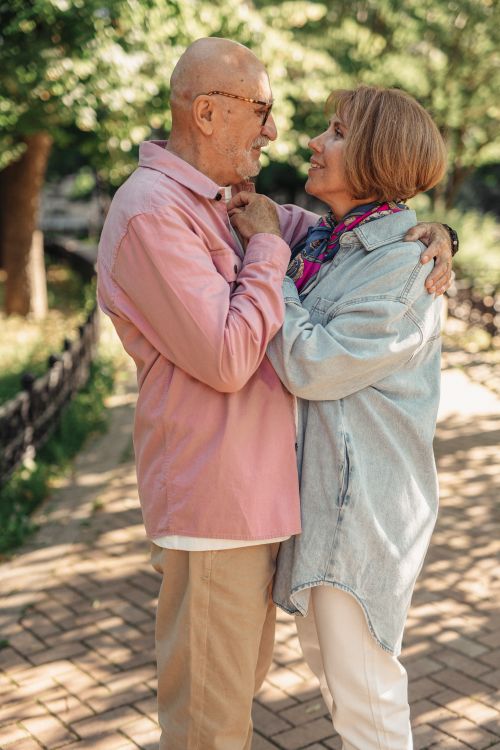 Free Heartwarming image of a senior couple embracing in a sunny outdoor setting. Stock Photo