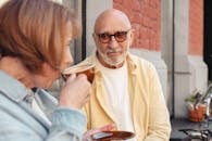 Man in Yellow Crew Neck Shirt Holding Brown Ceramic Mug