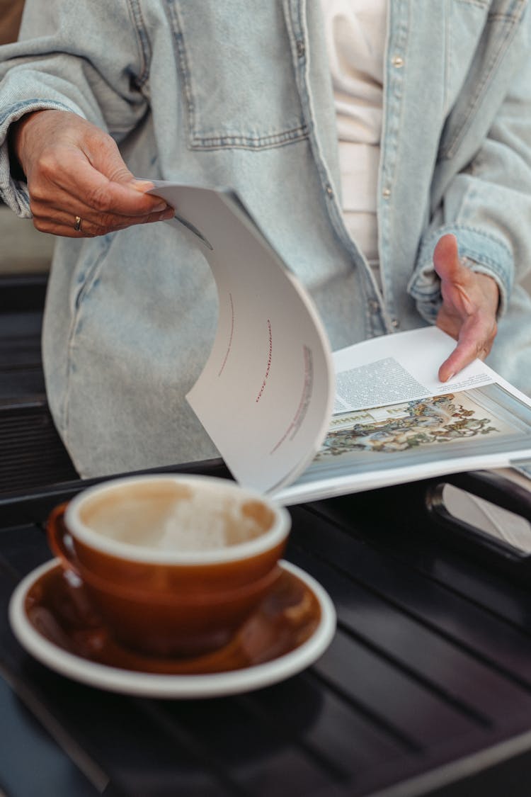 Close Up Photo Of A Person Reading Magazine