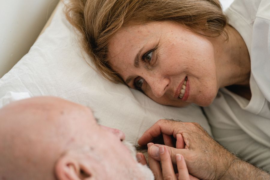 Caregiver gently assisting an elderly patient with grooming