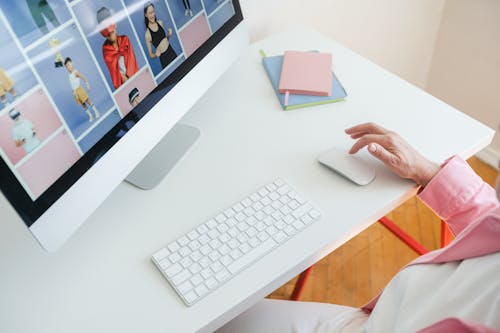 Person Using Computer On A White Table