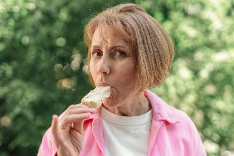 An Elderly Woman Eating An Ice Cream