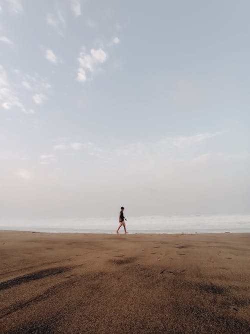 A Man Walking at the Beach