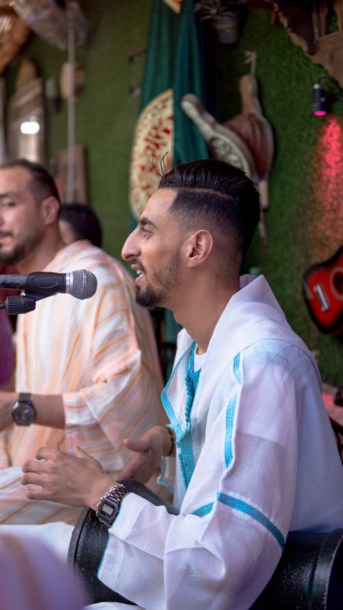 Man in White Button Up Shirt Singing