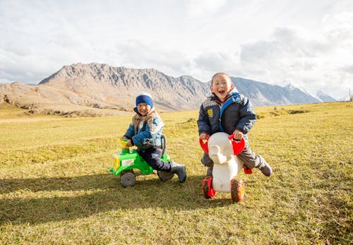 Free Happy Children Riding their Toys in the Altai Mountains Stock Photo