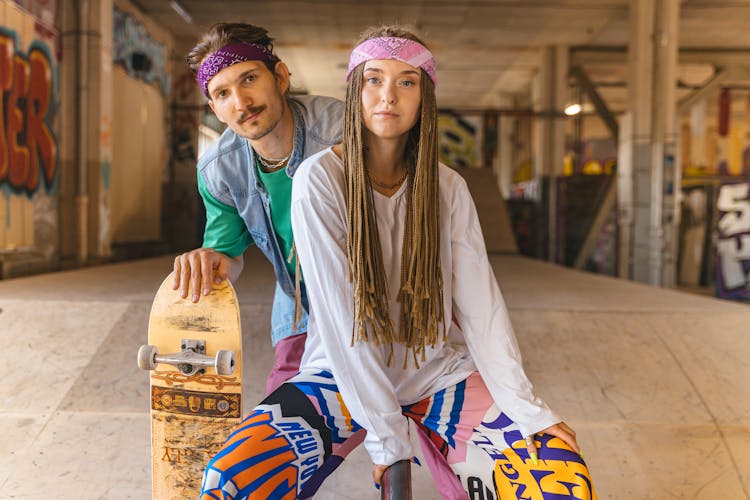 Couple In Colorful Clothes In Skate Park