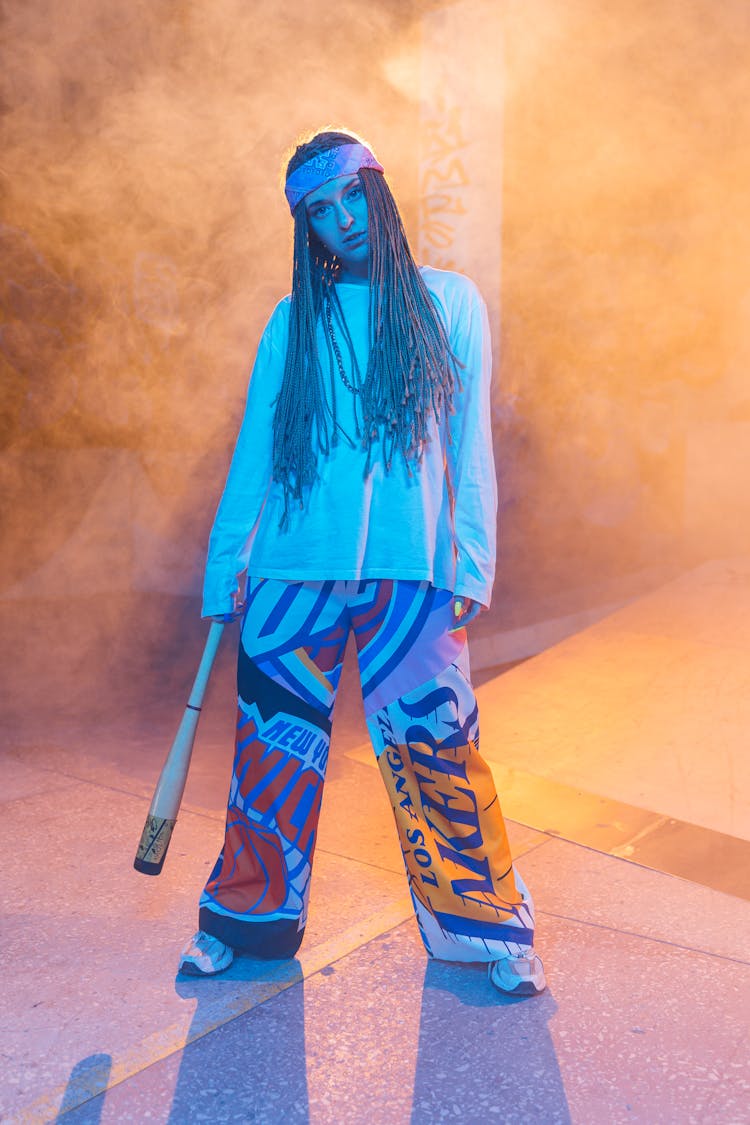 Woman Holding Baseball Bat In Mist