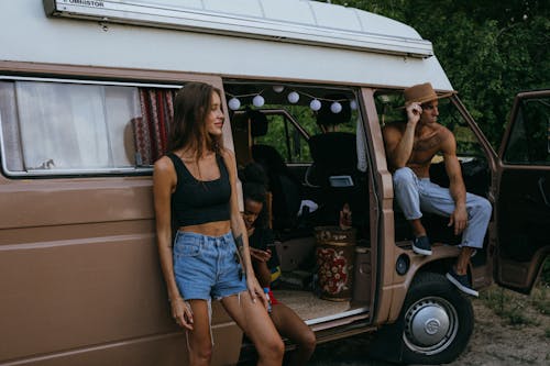 Free Friends Hanging Out by the Side of a Camper Van Stock Photo