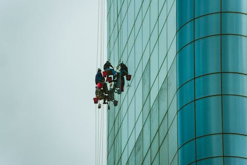 People Cleaning the Exterior of a Building