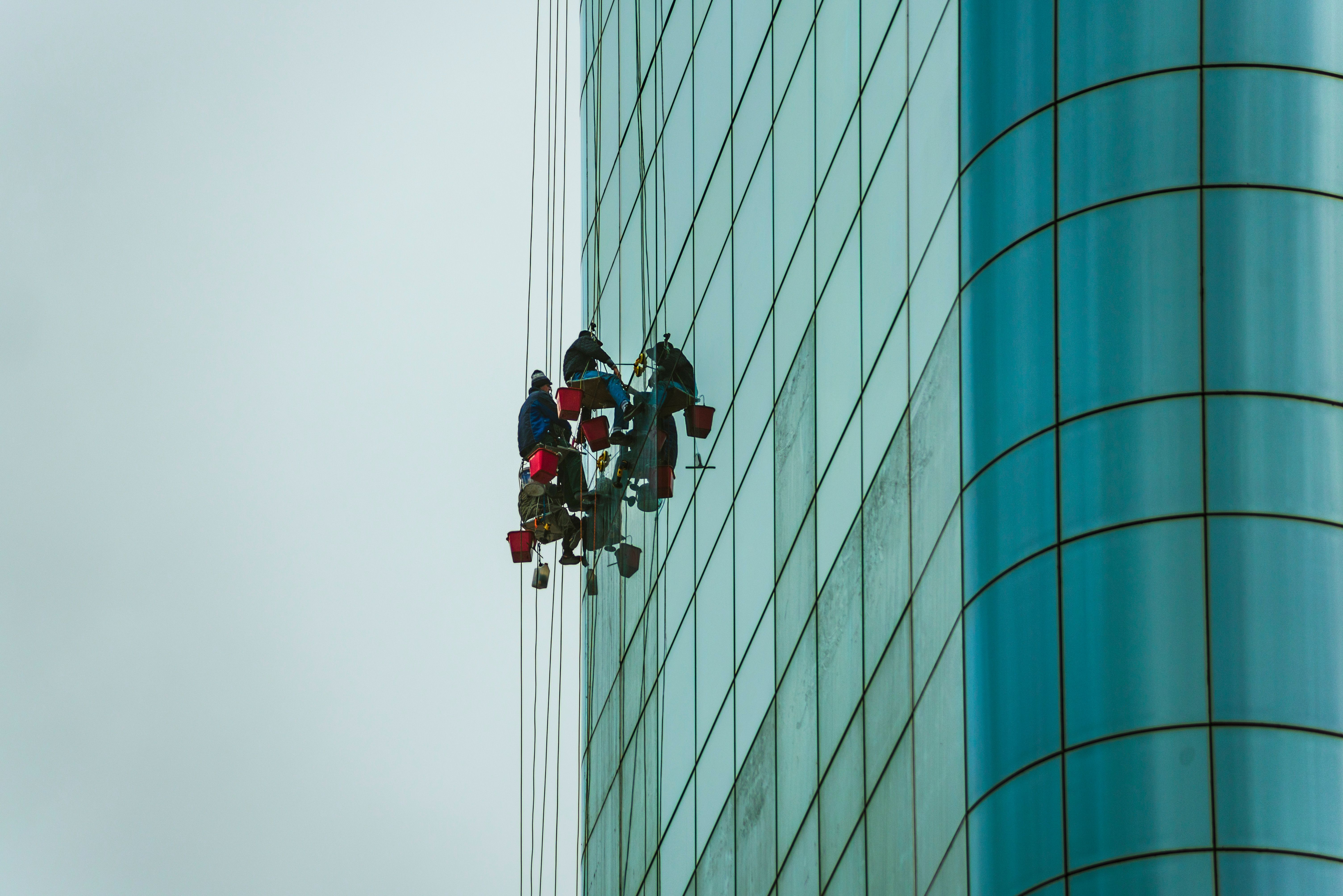 Workers cleaning the outside of a building