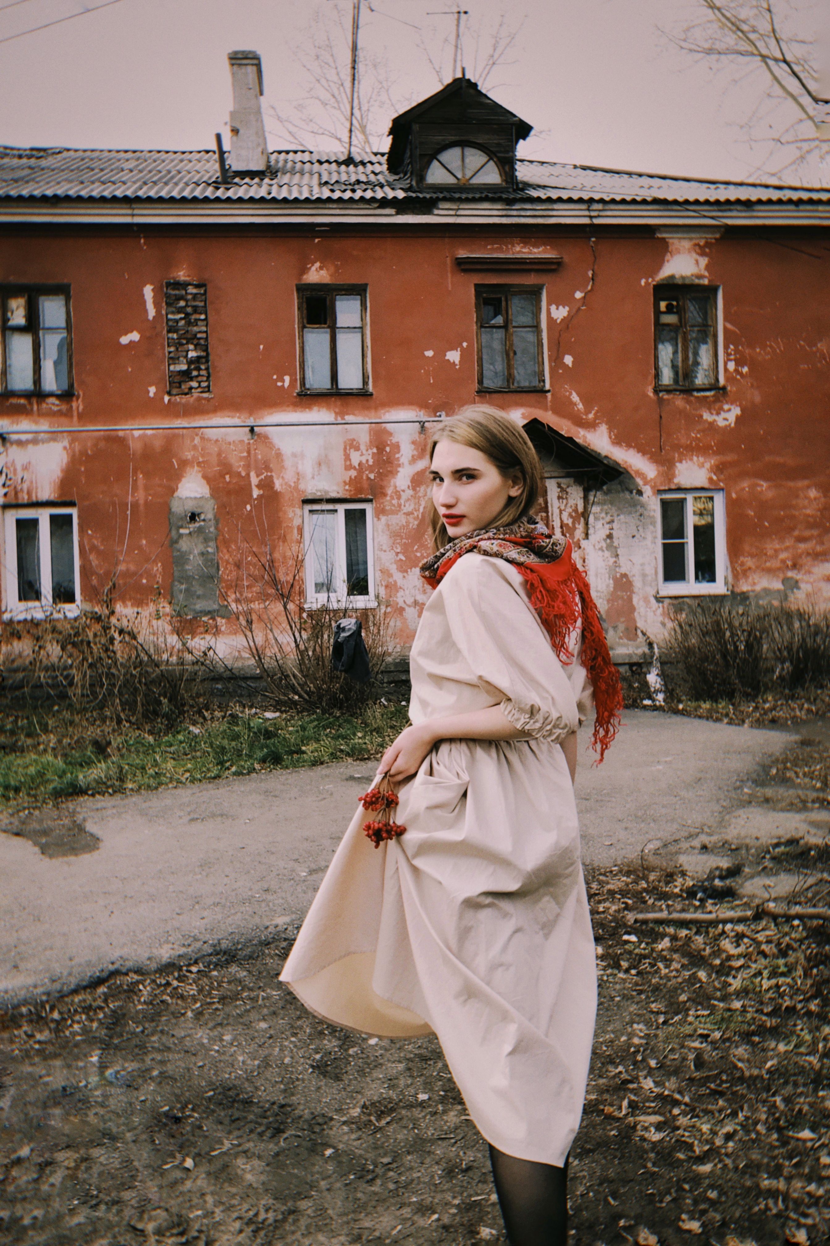 A Young Woman Posing in front of an Abandoned Building · Free Stock Photo
