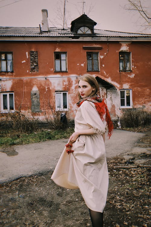 A Young Woman Posing in front of an Abandoned Building