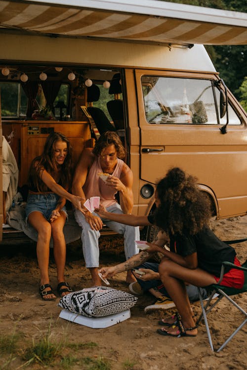 Free Friends Playing Cards by a Campervan  Stock Photo