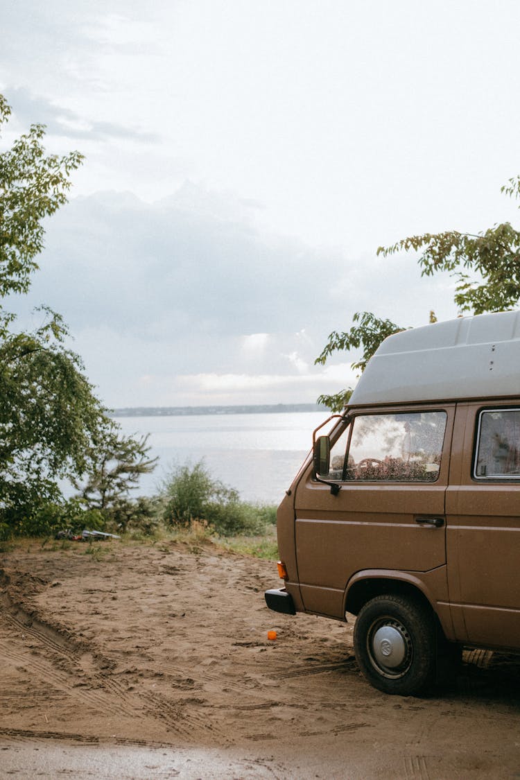 A Brown Van Near A Beach