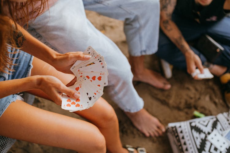 Close-Up Shot Of A Person Holding Cards