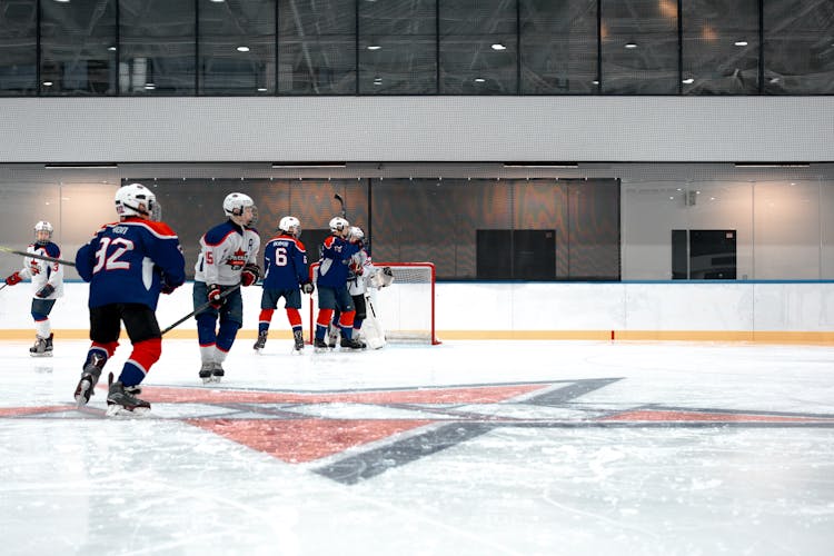 People Playing A Game Of Hockey