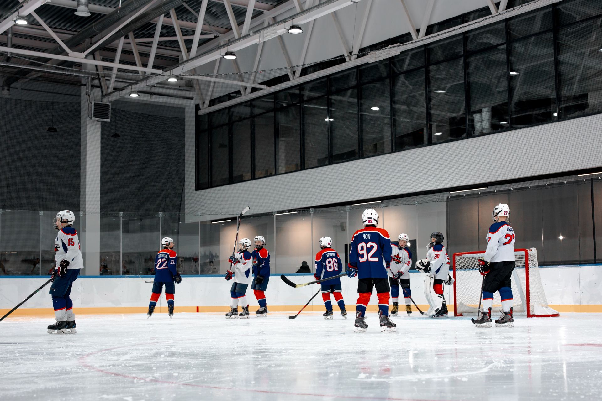 Dynamic scene of a high-energy ice hockey game indoors with players in action.