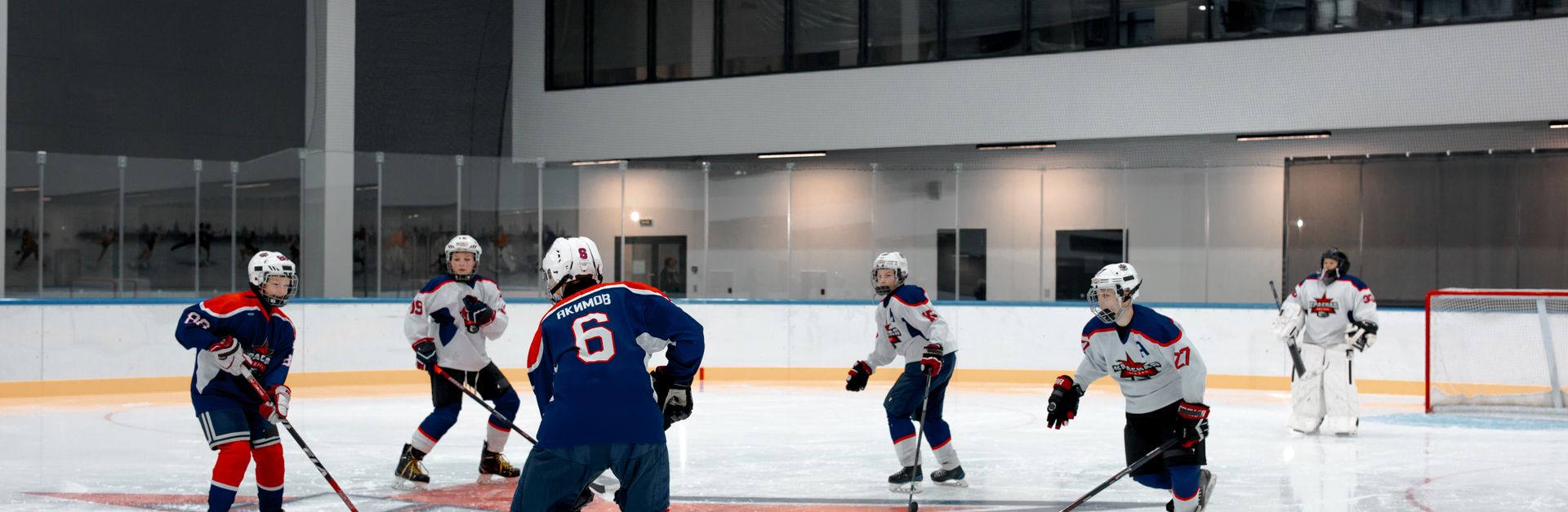 Dynamic ice hockey scene with players in an indoor rink ready for face-off. Captivating sports momen