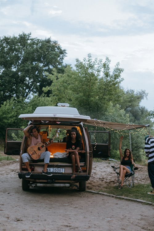 Free Young Friends Hanging Out at a Camper Van Stock Photo