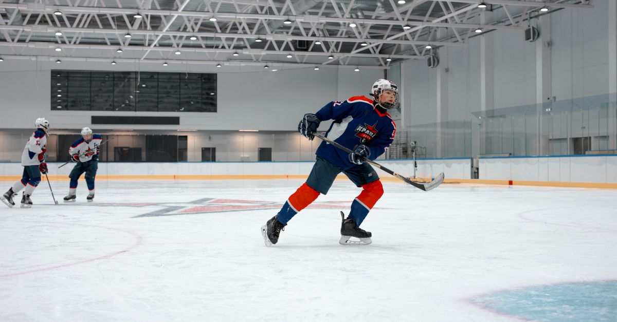 Intense ice hockey game with players in action at an indoor rink.