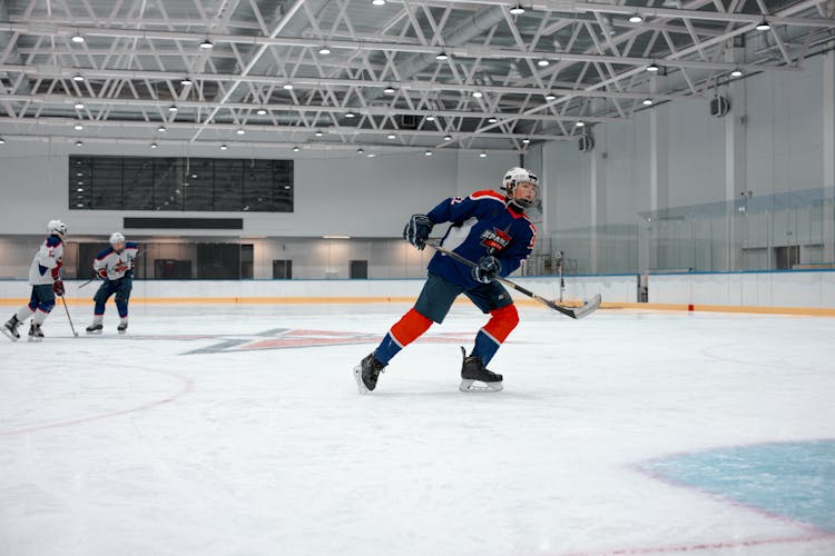 A Player Skating While Holding A Hockey Stick