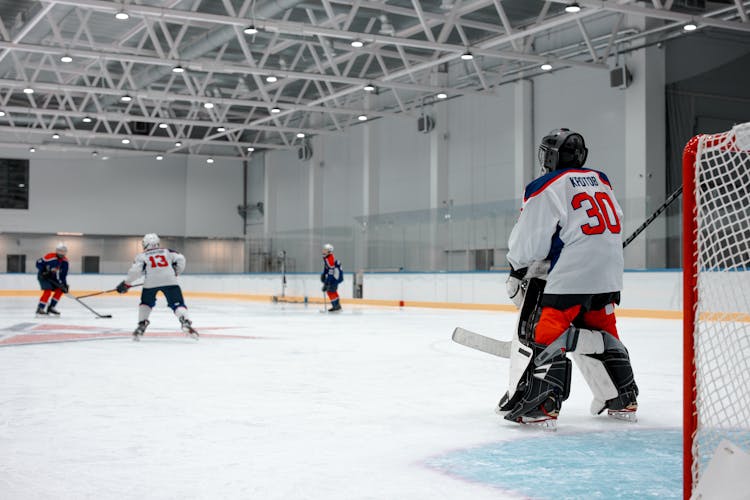 Man In White Ice Hockey Jersey Playing Hockey