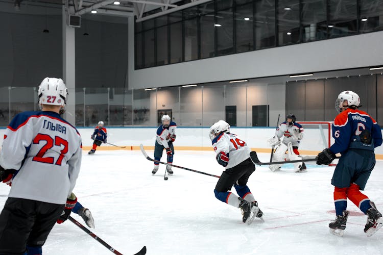 People Playing Hockey In An Ice Arena 