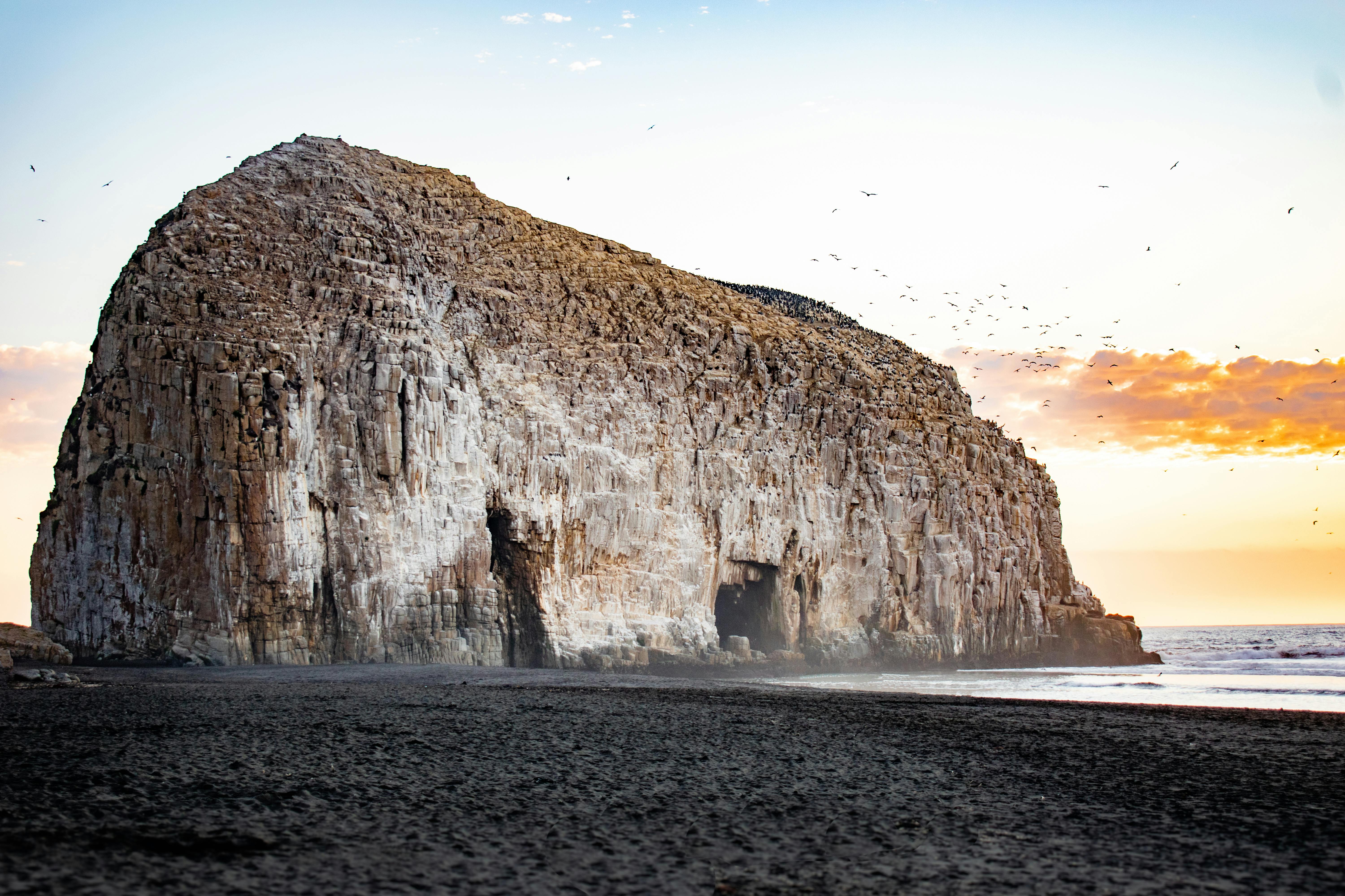 Stunning rocky landscape at Constitución Beach during sunset with tranquil waves.