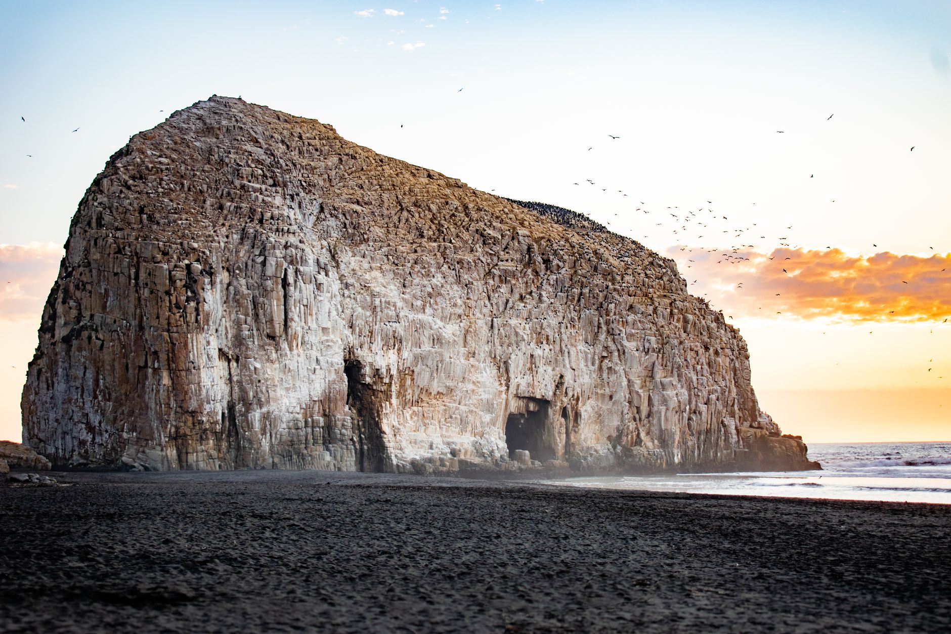 Stunning rocky landscape at Constitución Beach during sunset with tranquil waves.