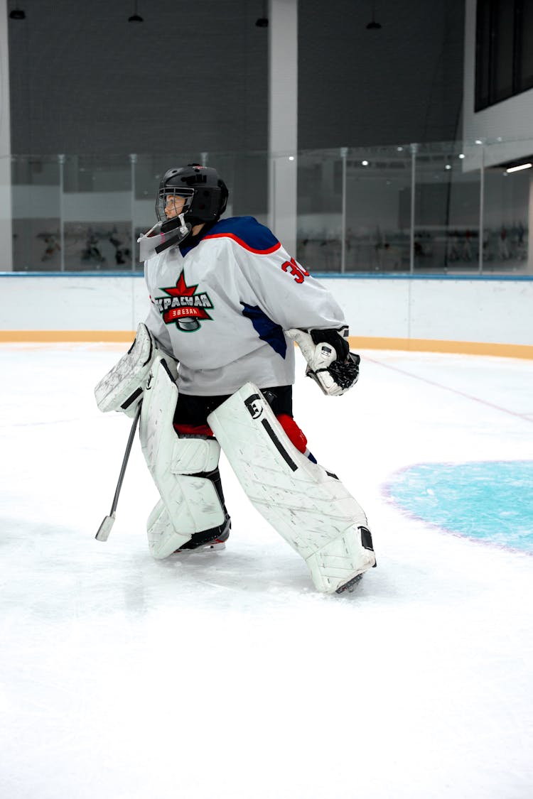 Hockey Player Playing At A Ice Rink