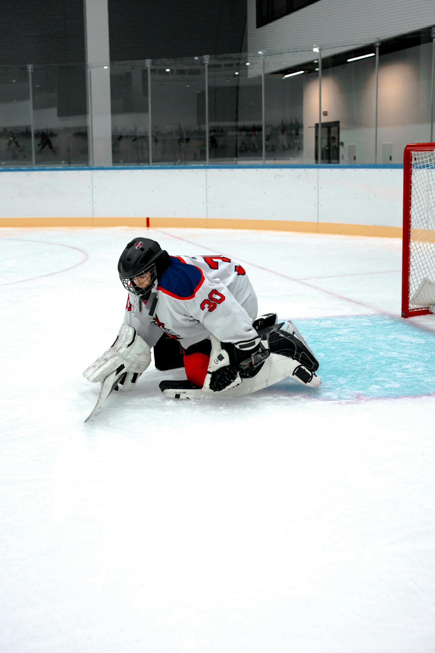 Ice hockey goalie in action during a game at an indoor rink