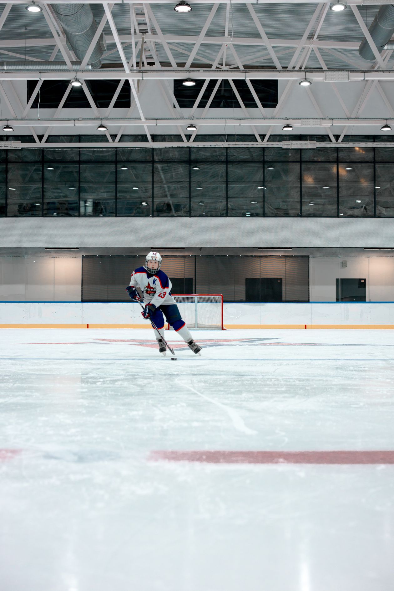 Hockey player skating on an ice rink