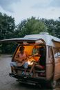 Friends Sitting at The Back of a Camper Van