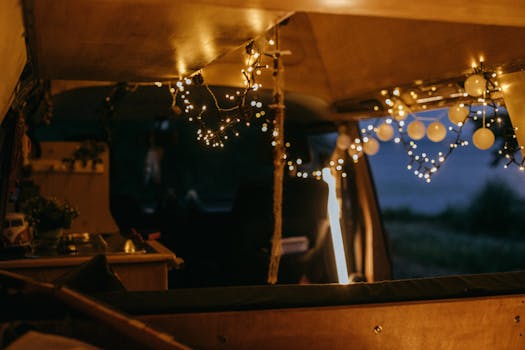 Warm and inviting van interior decorated with string lights, creating a cozy atmosphere.