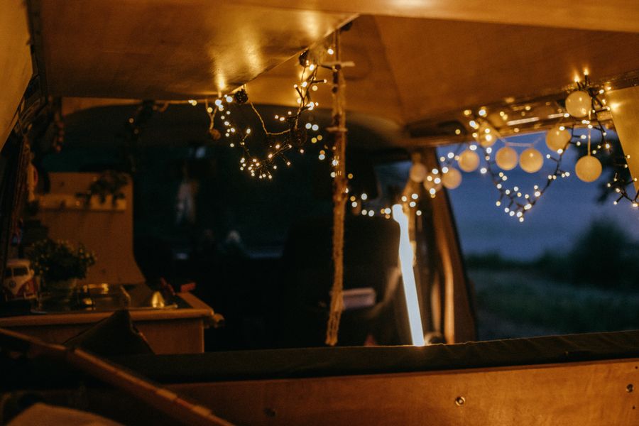 Van interior strung with fairy lights. Photo by KoolShooters on Pexels