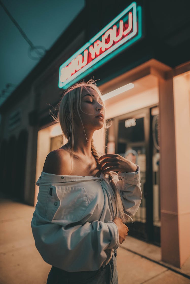 Woman In White Denim Jacket Standing Near The Store 