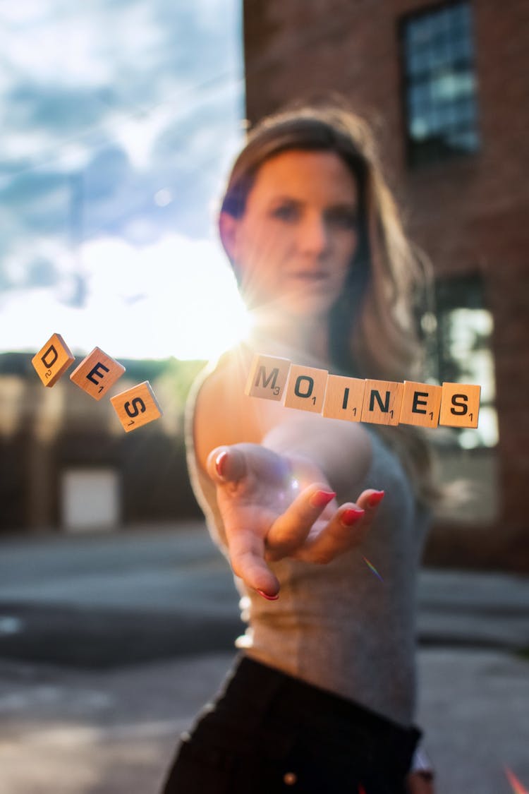 Woman Throwing Wooden Scrabble Tiles 