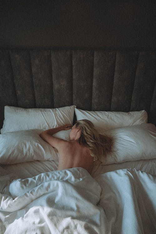 Free Topless Woman Lying on Bed Stock Photo